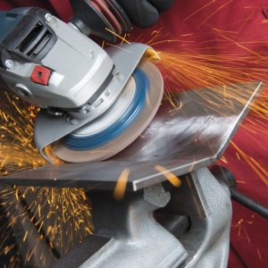 electric angle grinder in use on metal